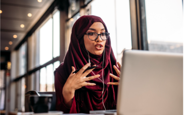 woman speaking in online meeting via laptop