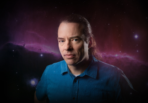 Travis Rector and his image of the Horsehead Nebula taken with the National Science Foundation's 0.9-meter telescope on Kitt Peak, Arizona superimposed behind him.