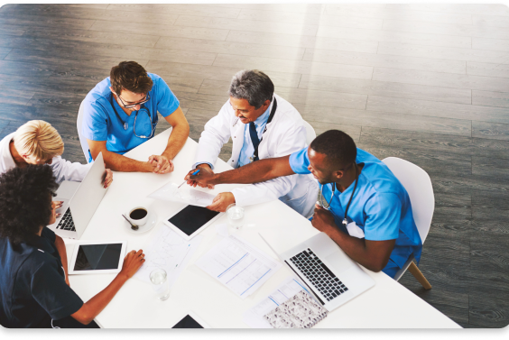 doctors at desk holding meeting 2