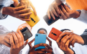 The image shows multiple people having mobile phones in their hands