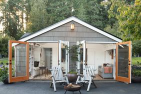 Tiny house in yard with two large doors