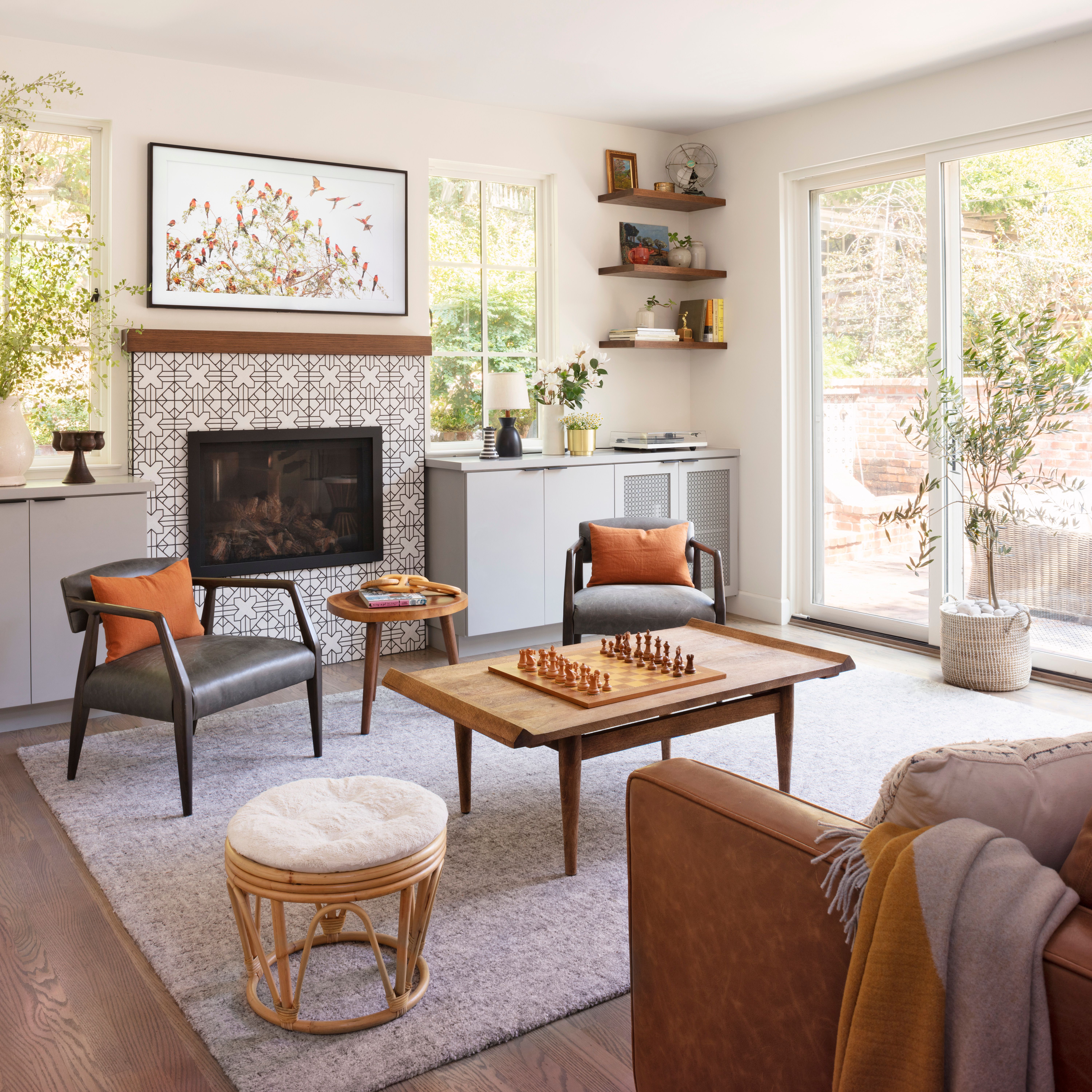 living room with cabinets flanking a pattern-tiled fireplace