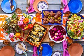 wood table with prepared foods floral centerpiece