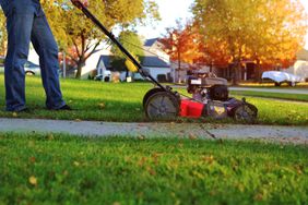 mowing lawn next to sidewalk