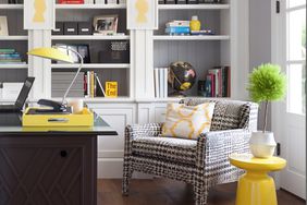 Office with bookshelves and yellow pops of color