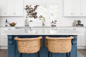 blue kitchen island with wicker bar stools