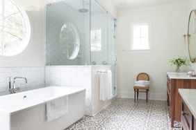 bathroom with glass walk-in shower and freestanding tub