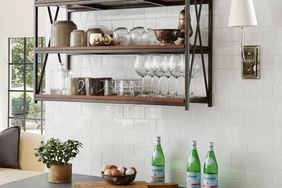 black stone countertops in kitchen with subway tile and floating shelf