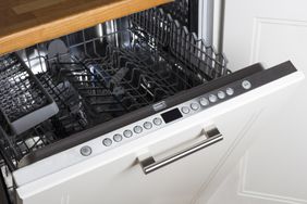 empty dishwasher halfway open showing buttons settings