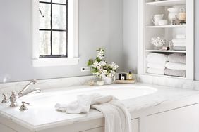 white bathroom built-in shelves bathtub