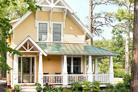 yellow farmhouse with olive-green front door