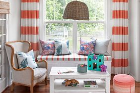 sunroom with striped curtains and window seat