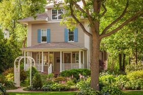 Home with large tree in front yard