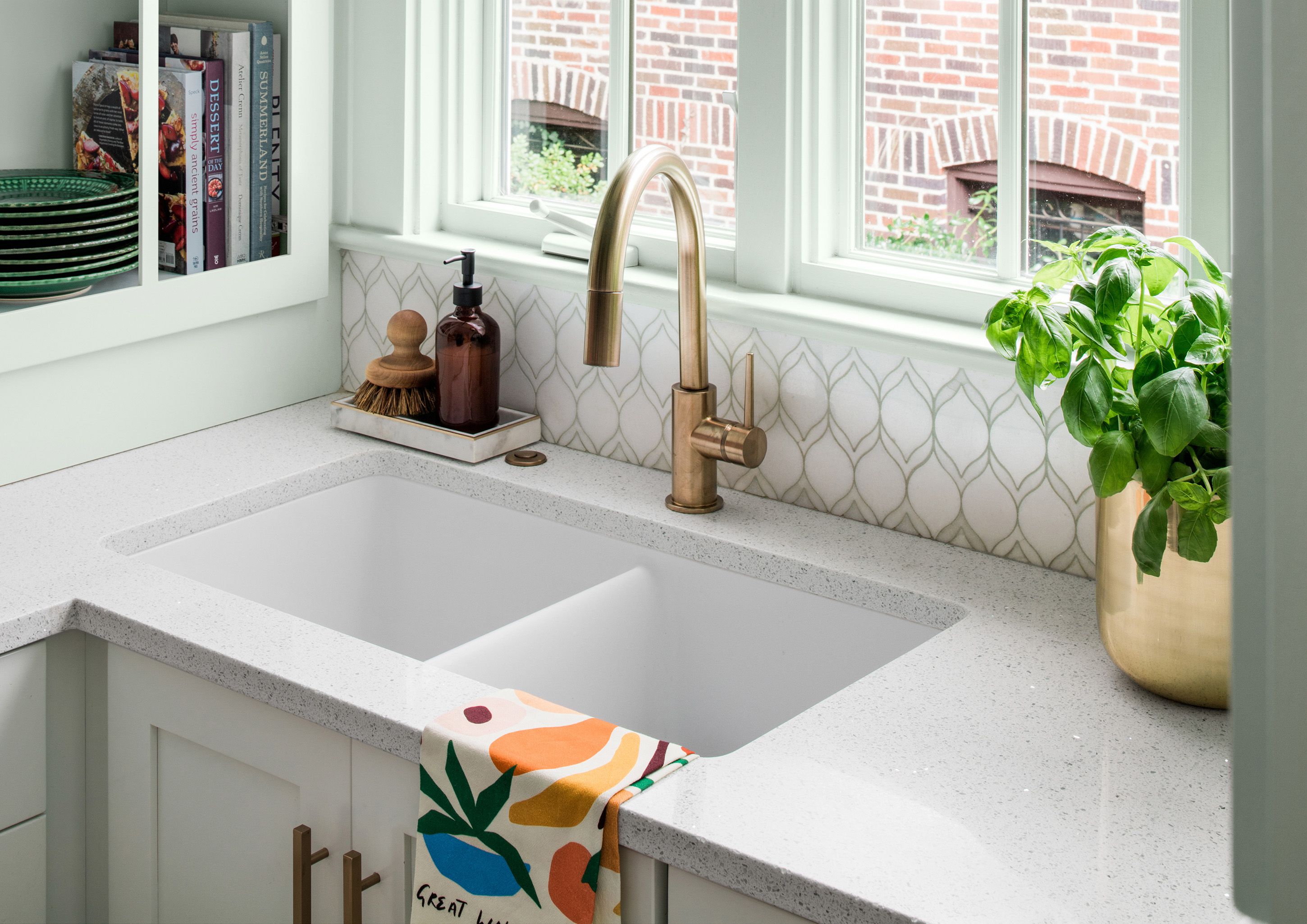 white kitchen sink with gold faucet