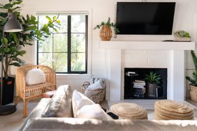 TV hanging over fireplace in decorated living room