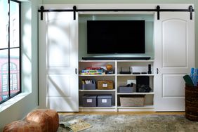 entertainment center with barn doors hiding tv