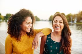 friends laughing by the river