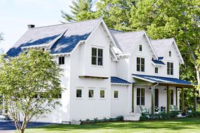 farmhouse exterior with wooden beams porch