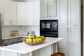 Kitchen with white counter and bar seating