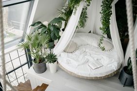 Round bed on a platform with potted plants