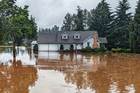 how to clean flooded home - blue house in floodwater