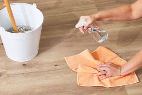 Spraying laminate floor with DIY cleaner