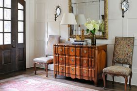 white entryway with red rug 