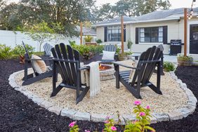 Outdoor fire pit with chairs and landscaping