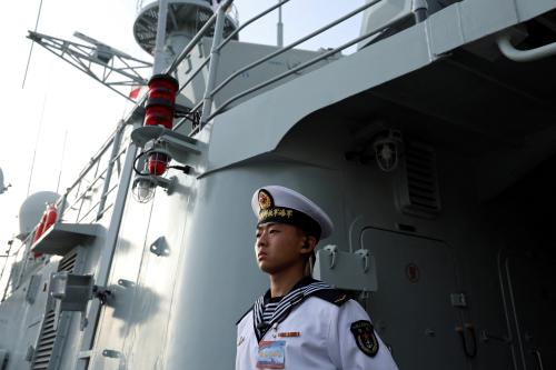 A member of the Chinese People's Liberation Army (PLA) Navy stands guard on the Shijiazhuang, a Type 051C guided-missile destroyer, as the Navy opens warships for public viewing to mark its upcoming 75th founding anniversary, at the port in Qingdao, Shandong province, China April 20, 2024.