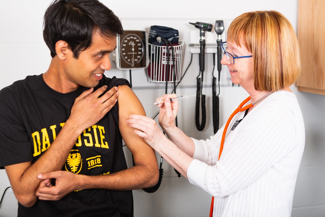 Nurse giving student a flu shot 