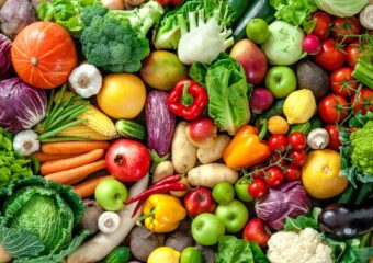 An overhead view of a variety of fresh vegetables and fruits.