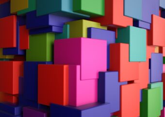 Colorful interlocking block pieces assembleld as part of a larger shape.