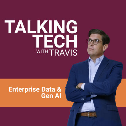 Title card for Talking Tech with Travis video episode, with Travis Vigil in a blue blazer and light blue shirt, standing in front of a maroon background with horizontal orange strip that includes episode topic.