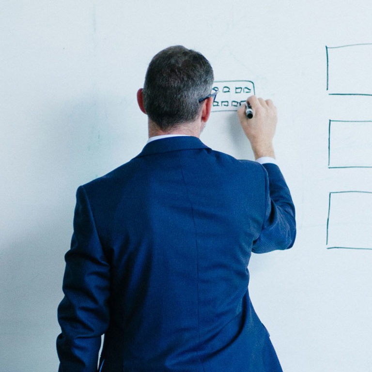 Ensono employee writing on a board