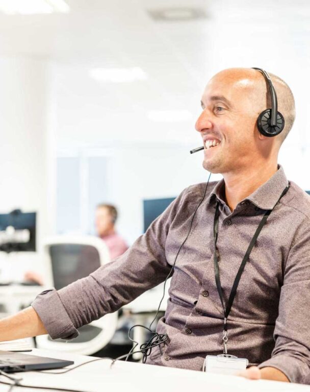 Man with headset on working on computer