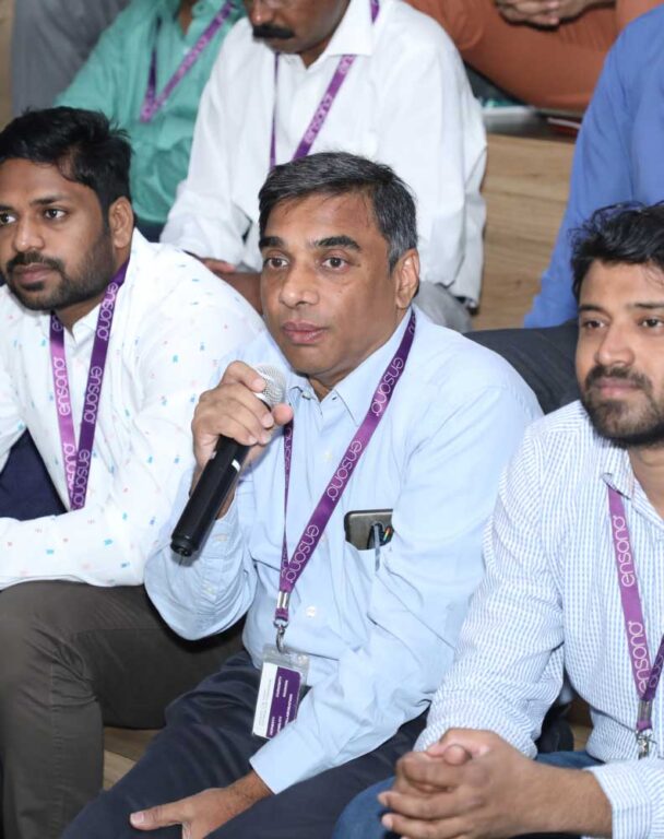 Group of coworkers at an Ensono conference with microphone