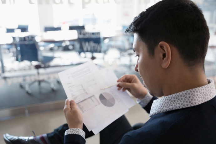 Businessman reviewing financial data paperwork office