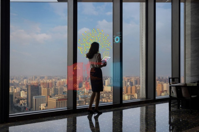 EY business woman in front of glass windows