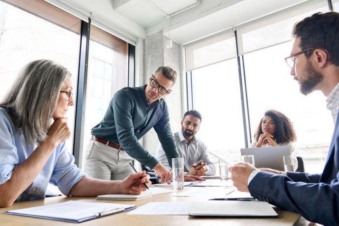 Male mature caucasian ceo businessman leader with diverse coworkers team, executive managers group at meeting