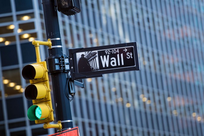 Wall street sign with blurred building in bkgd