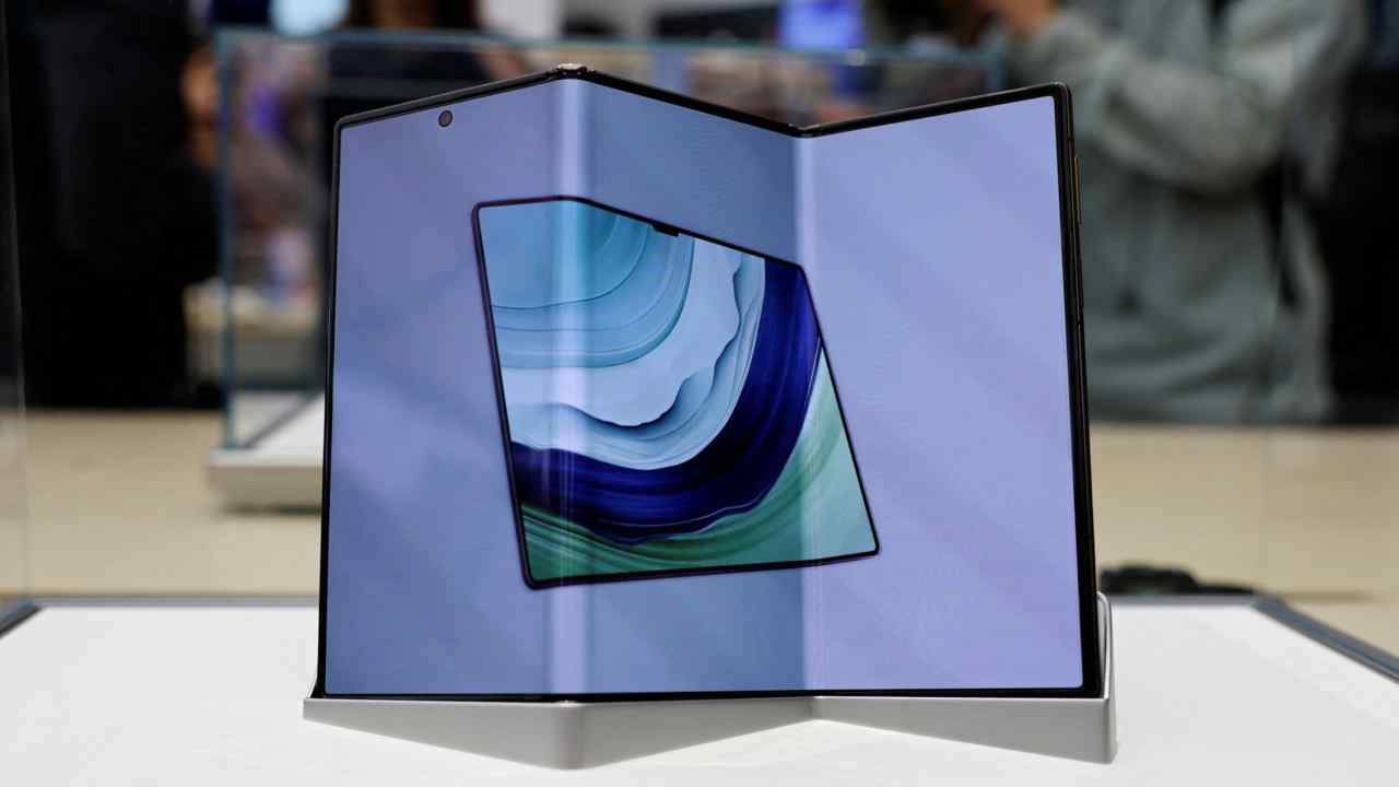 Huawei's new trifold smartphone, the Mate XT, is displayed in a glass case at a Huawei flagship store in Beijing, China.