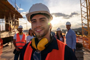 stock image of construction workers at work site smiling at camera