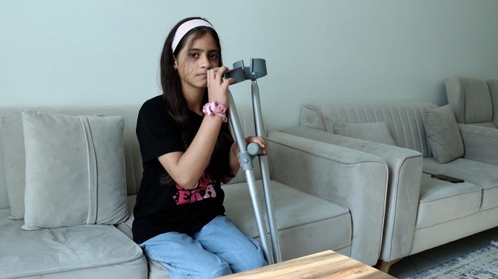 Dana Dabour, 12, sits in an apartment in Doha, Qatar