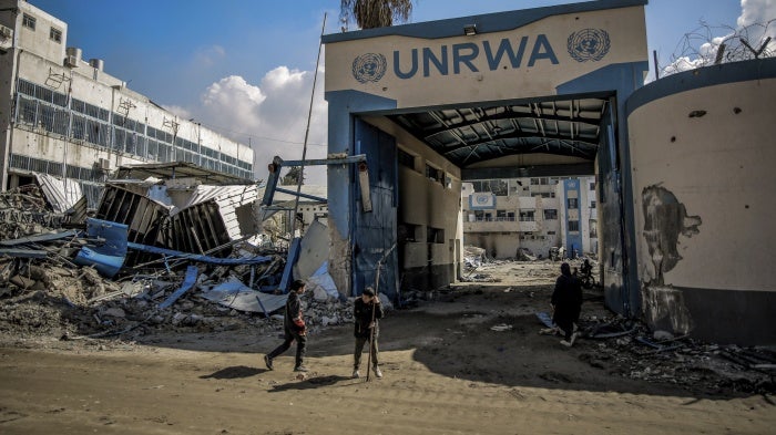 Palestinians examine damage to the United Nations Relief and Works Agency for Palestine Refugees (UNRWA) buildings