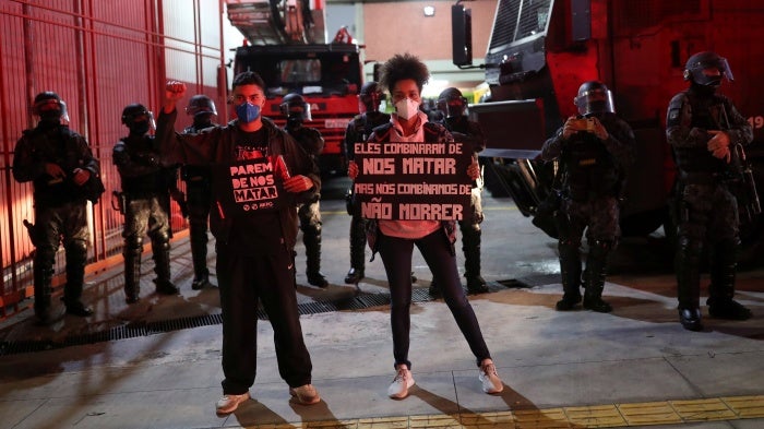 Activists protest in Sao Paulo against racism, police violence, and against a police operation that took place in Jacarezinho in Rio de Janeiro, Brazil, May 13, 2021. The placards read "Stop killing us" and "They agreed to kill us, and we agreed not to die".