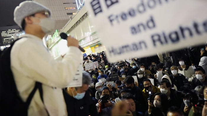 Protesters rally in Tokyo to support the victims of a recent fire in Urumqi, the capital of China's Xinjiang region, November 30, 2022.