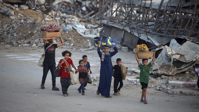 Displaced Palestinians leave al-Bureij refugee camp, in central Gaza, after the Israeli military issued a new evacuation order, on July 28, 2024. © 2024 Majdi Fathi/NurPhoto via AP