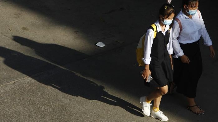 Cambodian school girls walk home at the end of their school day outside Phnom Penh, Cambodia.