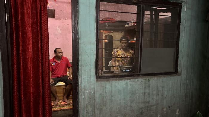 Purna’s wife, Kabita, preparing dinner the night before his dialysis while he assists, Butwal, Nepal, July 19, 2023.