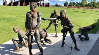 A sculpture of African slaves by Ghanaian artist, Kwame Akoto-Bamfo, at the beginning of the National Memorial for Peace and Justice in Montgomery, Alabama. 